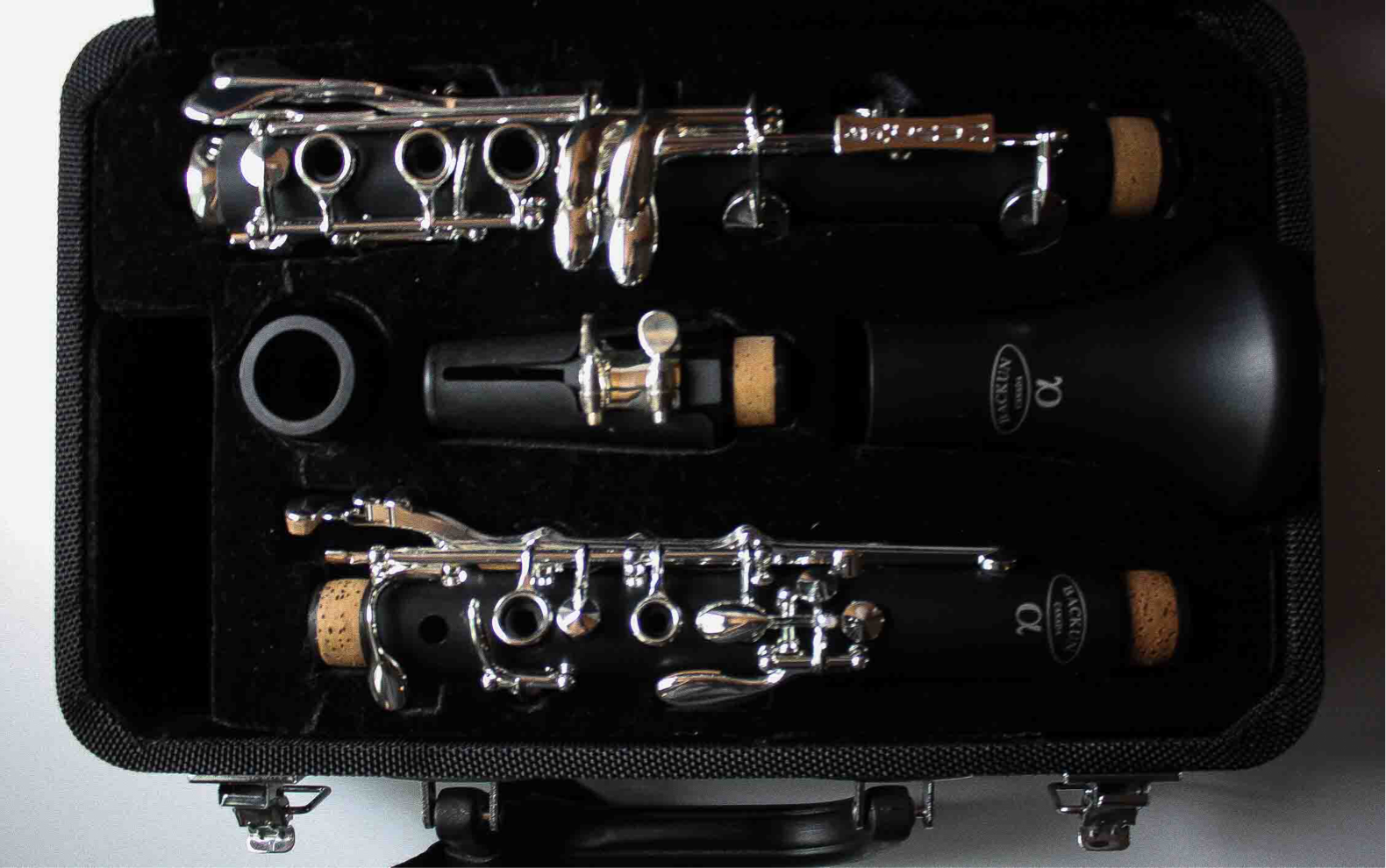 The unassembled clarinet on its case
