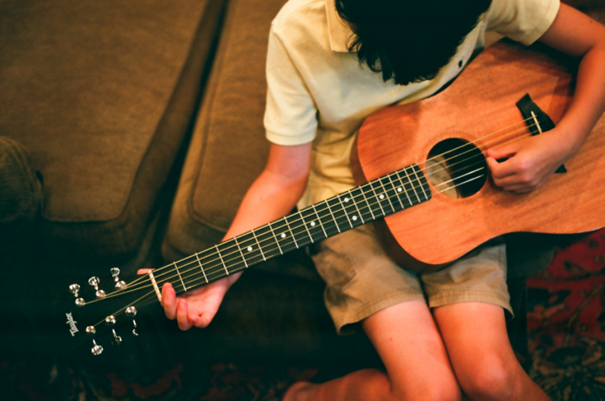 Left handed boy with guitar