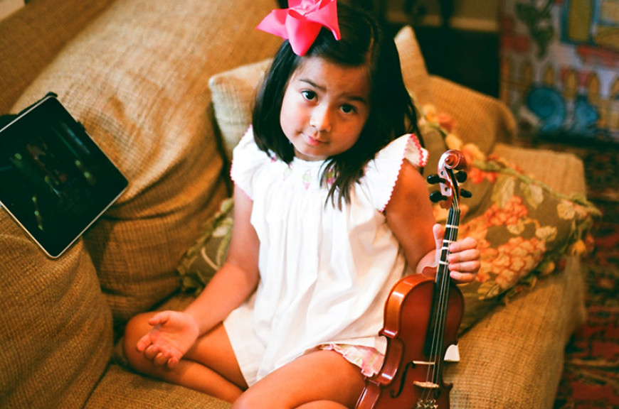 little nina with violin, ipad, and hairbow