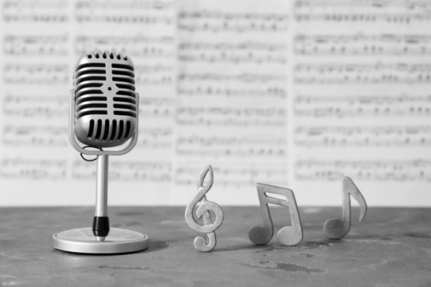 Microphone and sheet music on a table.