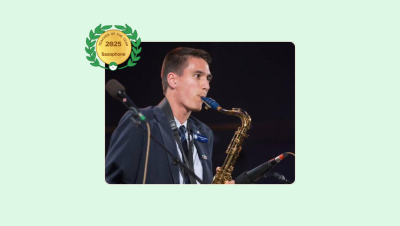 Image of Andrew Larsen playing the Saxophone while performing on stage