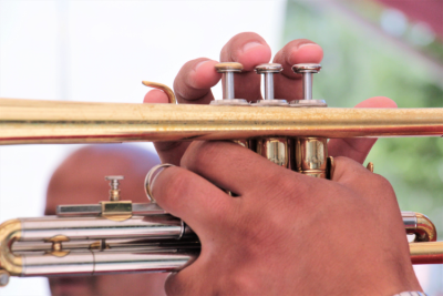 Close up of trumpet player's hands on instrument.