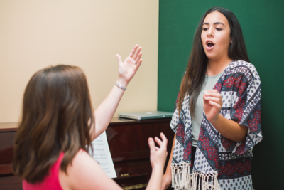 Vocal coach working with voice student.