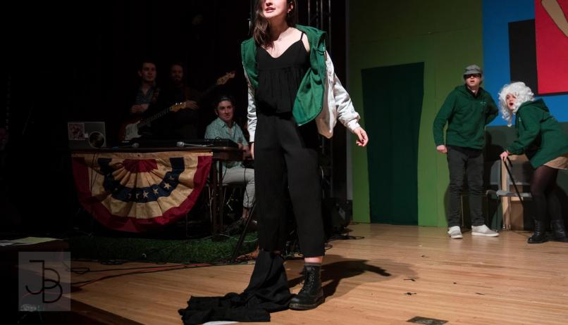 comedian Amara Leonard performing improv on a stage