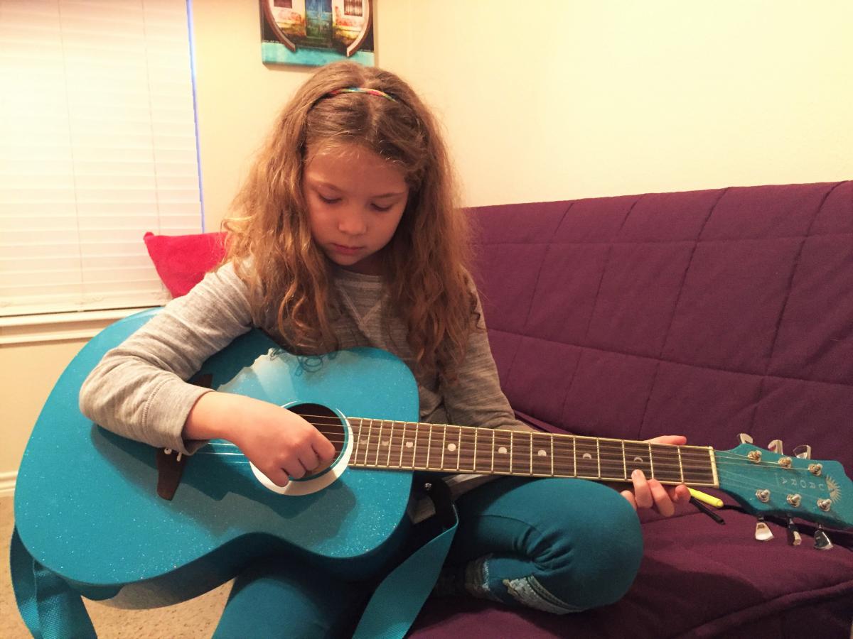 isabella with a sparkly blue guitar