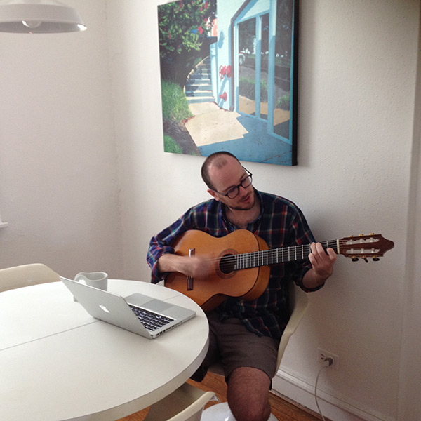 guy with guitar and computer