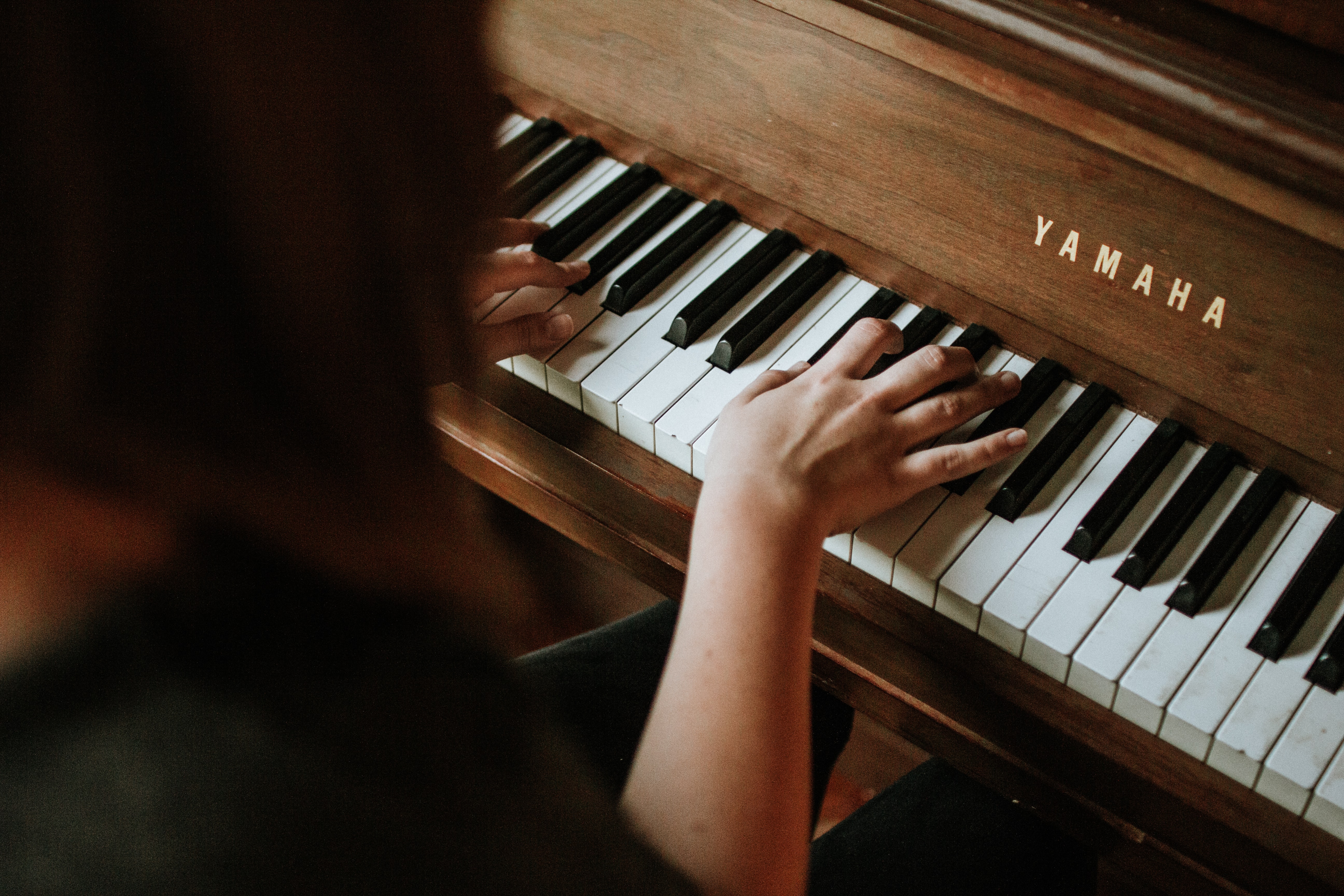 Person playing a Yamaha piano