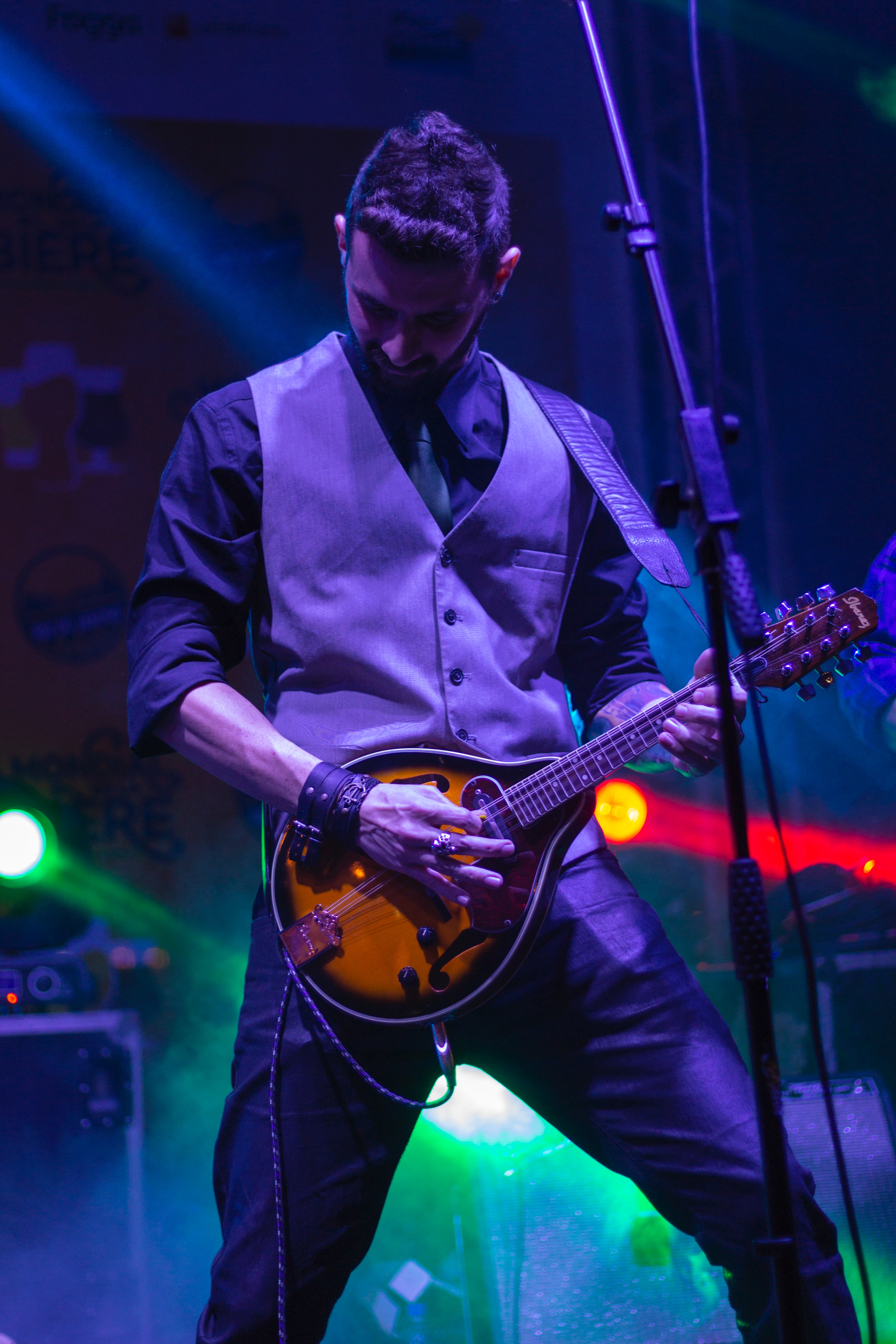 Guy playing mandolin on stage