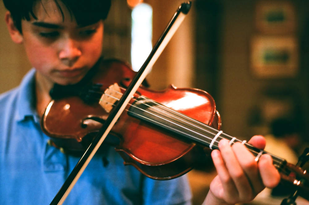 Teenager practicing violin